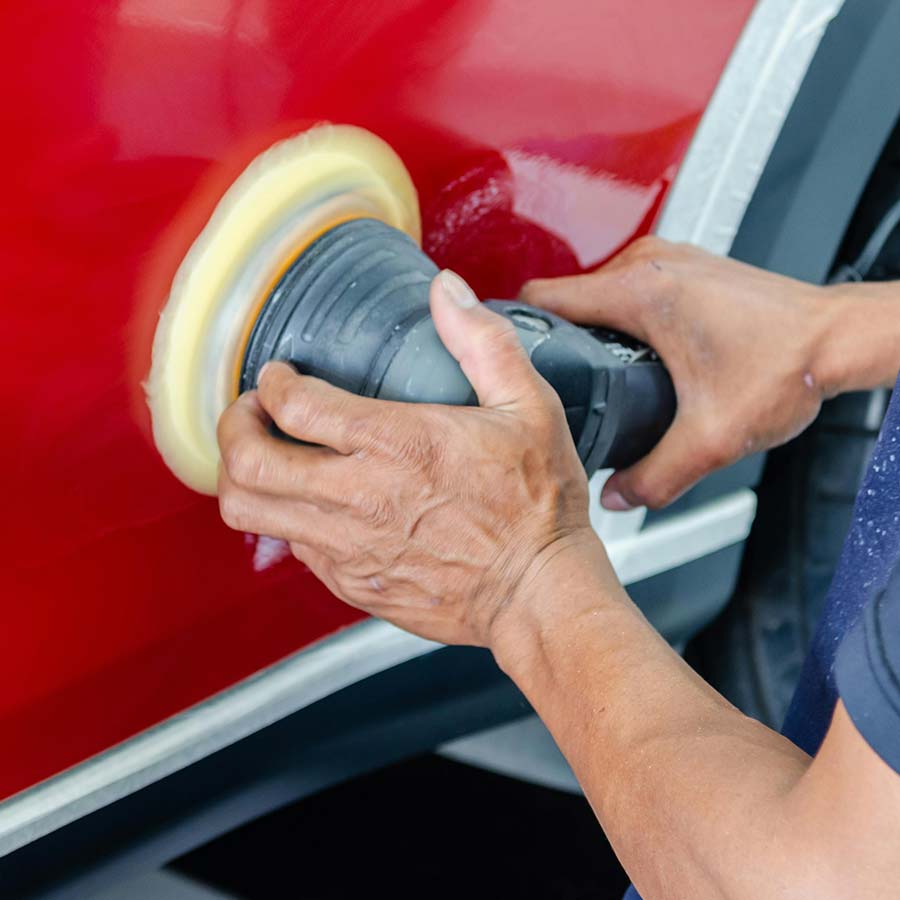 man hand polishing car panel